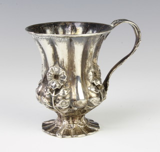 A William IV repousse silver mug with floral decoration and fluted body, London 1831, maker Joseph Angell I & Joseph Angell I 151 grams, 9cm 