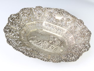 A 19th Century Continental pierced and repousse silver dish with scrolling floral border enclosing a fete gallant view 419 grams 32cm 