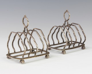 A pair of Victorian silver 5 bar toast racks on ball feet, London 1891, maker Henry Wilkinson & Co 248 grams