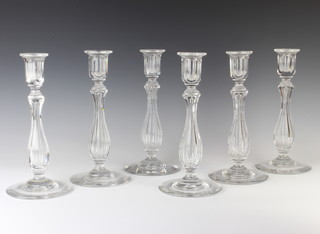 A set of 6 19th Century clear glass candlesticks with baluster stems 27cm 