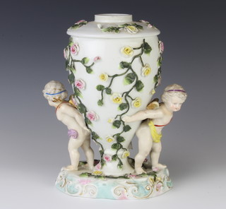 A 19th Century German porcelain lamp base with 2 cherubs supporting a floral encrusted vase  26cm 