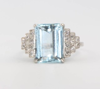 A white gold Art Deco style aquamarine and diamond ring, the centre stone approx. 5.5ct flanked by brilliant cut diamonds approx. 0.4ct, size N 
