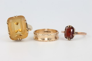A 9ct yellow gold quartz dress ring size Q 1/2, a 9ct wedding band size O and a 9ct gem set ring size R 
