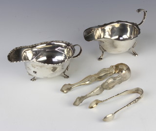 A silver sauce boat with S scroll handle on hoof feet Birmingham 1973, 1 other and 2 pairs of silver sugar nips, 230 grams