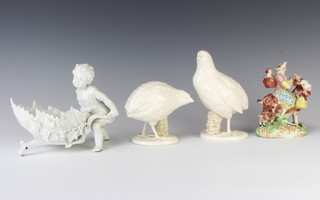A pair of Italian white glazed figures of birds 8cm, a Staffordshire figure of a goat with figures 13cm and a German white glazed figure of a child pushing a vinous below 17cm 