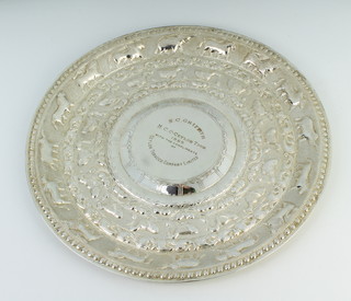 An Indian repousse silver circular salver decorated with animals and birds with presentation inscription 420 grams, 30 cm, boxed