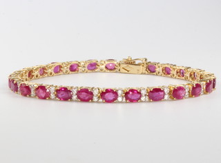 An 18ct yellow gold ruby and diamond line bracelet, the diamonds approx. 0.72ct the rubies approx. 10.3ct, 17cm 
