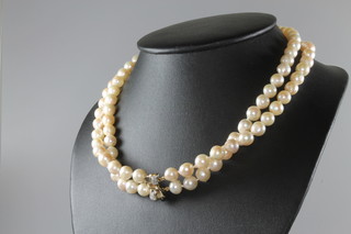 A double strand cultured pearl necklace, the 14ct yellow gold clasp set with diamonds, 45cm 