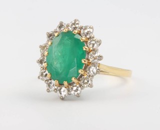 An 18ct yellow gold emerald and diamond oval cluster ring, the centre oval stone approx. 4ct surrounded by 14 brilliant cut diamonds approx. 0.65ct size S 1/4