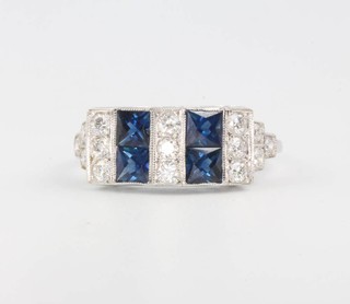 An 18ct white gold Art Deco style sapphire and diamond ring with princess cut sapphires and brilliant cut diamonds size O 1/2