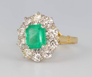 An 18ct yellow gold emerald and diamond cluster ring, the centre cut stone approx 1.35ct surrounded by brilliant cut diamonds approx. 1.5ct, size N 
