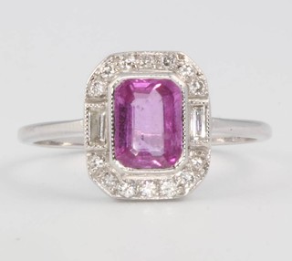 An 18ct white gold pink sapphire and diamond cluster ring, the centre stone approx 1ct surrounded by brilliant and baguette cut diamonds approx. 0.2ct, size N 