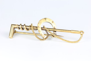 An Edwardian 15ct yellow gold bar brooch in the form of a crop and horse shoe 3.3 grams