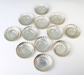 Twelve sterling silver scalloped dishes, 10cm, 763 grams 