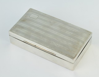 A silver engine turned rectangular cigarette box Birmingham 1926, 15cm x 3.5cm x 8cm 