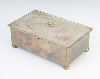 A rectangular silver cigarette box with laurel decoration raised on ball feet Birmingham 1939, maker Alfred E Jones 16cm x 5cm x 10cm 