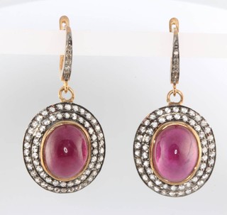 A pair of 14ct yellow gold oval cabochon cut ruby and diamond earrings 