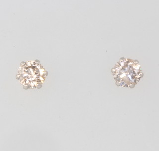 A pair of platinum and diamond ear studs approx 0.3ct, colour K/L SI1/SI2