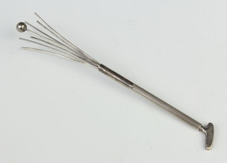 A novelty silver cocktail stirrer in the shape of a putter 