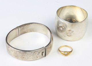 An 18ct yellow gold ring shank, 3 grams, size L, together with a silver bangle and a napkin ring 