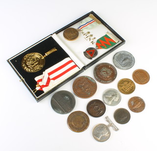 A cased CGIAA medallion with ribbon in a Spink box, minor medallions and coins