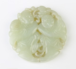 A carved jade pendant in the form of 2 standing gentleman 6cm diam. 