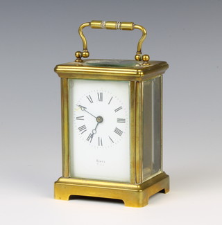 A 19th/20th Century carriage timepiece with enamelled dial and Roman numerals contained in a gilt metal case, the dial marked VOKFS Paris