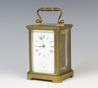 A French carriage alarm clock with enamelled dial and Roman numerals contained in a gilt metal case