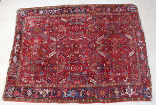 A red and blue ground Persian Heriz carpet 308cm x 243cm 