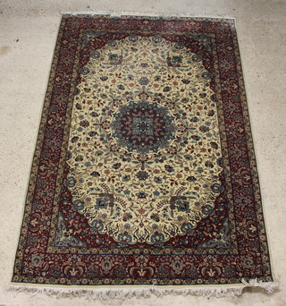 A  white and brown ground Persian carpet with central medallion within multi row borders 288cm x 186cm 