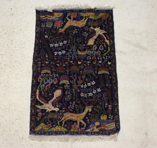A blue ground Persian carpet decorated panels 147cm x 85cm 