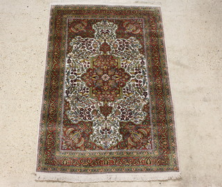 A white and brown ground Persian rug with central medallion and bird decoration 190cm x 122cm 