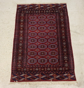 A red and blue ground Bokhara rug with 24 octagons to the centre 200cm x 126cm 