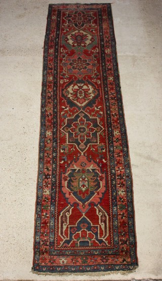 A Caucasian style runner with 7 octagons to the centre within a multi row border 416cm x 102cm 