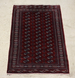 A red and blue ground Bokhara rug with 45 octagons to the centre within a multi row border 