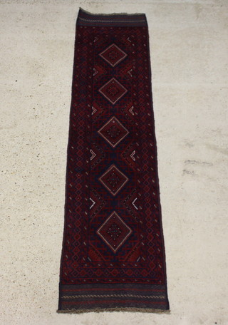 A blue and red ground Meshwani runner with 5 diamonds to the centre within a multi row border 