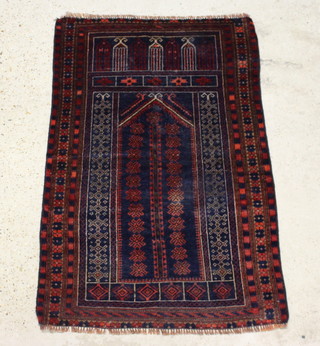 A blue and red ground Baluchi prayer rug 128cm x 85cm 