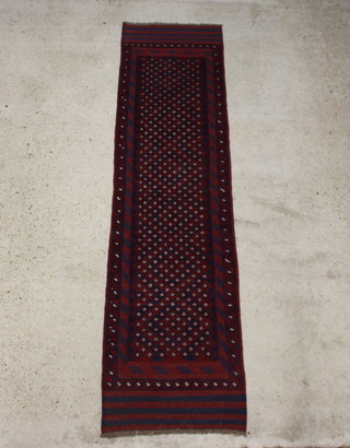 A red and blue ground Meshwani runner with 6 diamonds to the centre within multi row borders 260cm x 65cm 