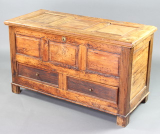 An 18th Century elm mule chest of panelled construction and with hinged lid, the base fitted 2 drawers 74cm h x 129cm w x 57cm d 