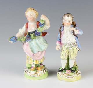 A Dresden figure  of a girl holding a vinous garland 11cm and a ditto of a boy holding a basket of flowers on his back 10cm 