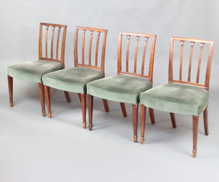 A set of 4 19th Century mahogany stick and rail back dining chairs with over stuffed seats raised on square tapered supports ending in spade feet 
