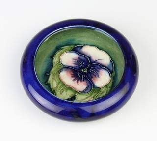 A Moorcroft shallow bowl the blue ground decorated with a flower, impressed marks 11cm 