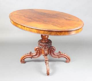 A handsome Victorian Irish oval mahogany centre table with quarter veneered top, raised on a carved column and tripod base 70cm h x 118cm w x 78cm d 