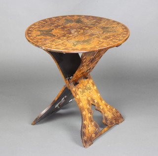An Art Nouveau circular Moorish style folding occasional table with poker work decoration 64cm x 62cm 
