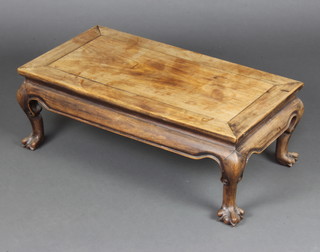 A Chinese rectangular bleached Padauk wood opium table raised on claw supports 28cm x 77cm x 41cm 
