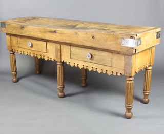A Continental butcher's block, raised on an associated made up base fitted 2 drawers with a carved and pierced apron, raised on 6 turned and reeded supports 89cm h x 200cm w x 62cm d