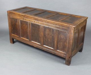 An 18th Century oak coffer of panelled construction with hinged lid, fitted a candle box 71cm h x 142cm w x 55cm d