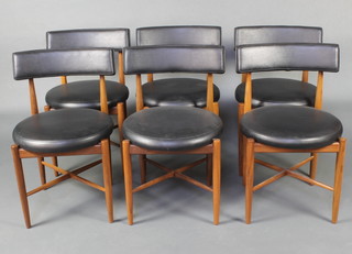 Kofod Larsen for G-Plan, a set of 6 mid 20th Century teak framed dining chairs with rexine upholstered seats and backs, raised on turned supports with X framed stretchers 
