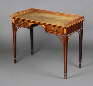 An Edwardian Georgian style inlaid mahogany writing table with pierced 3/4 gallery, the top with inlaid feather banding fitted 2 short drawers with fret work decoration raised on square tapered supports 75cm h x 91cm w x 45cm d 