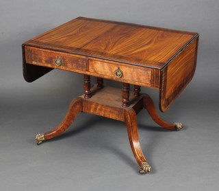 A Regency inlaid and crossbanded mahogany pedestal sofa table fitted 2 drawers raised on 4 columns with a platform base and splayed feet with brass caps and casters 70cm h x 86cm x 68cm 
 